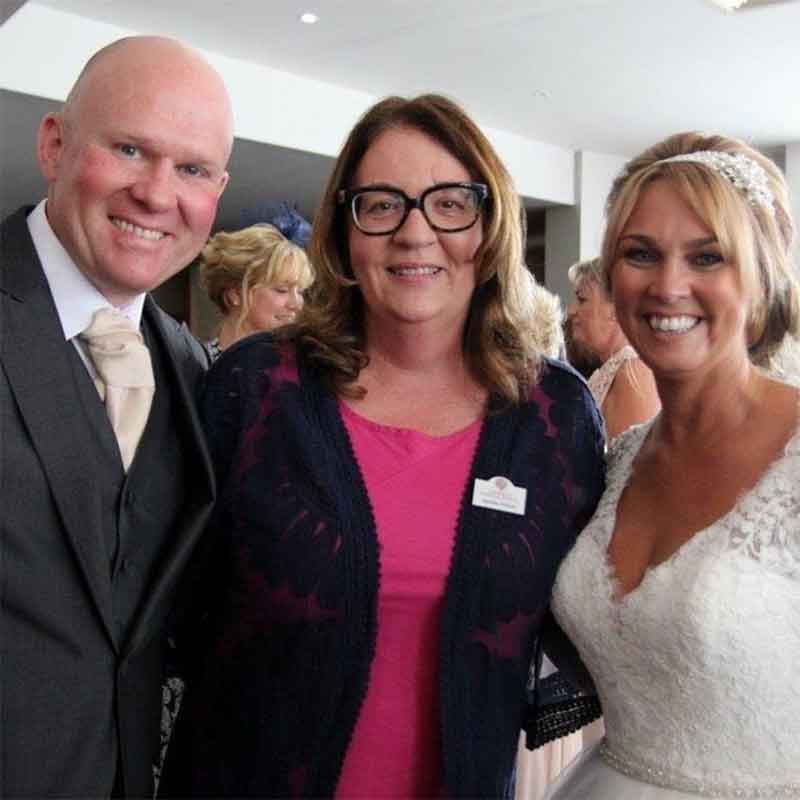 Jeanette with a happy bride and groom